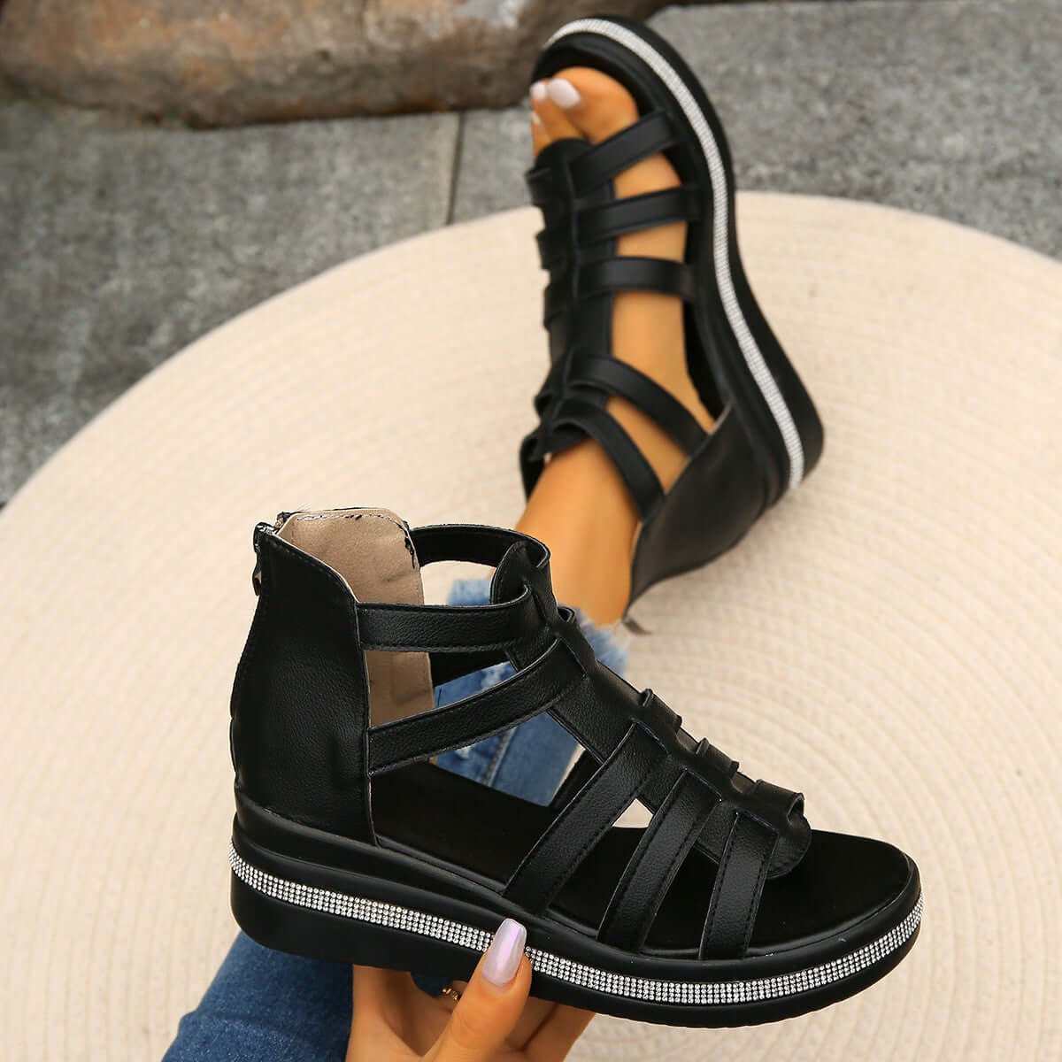 Cutout Rhinestone Trim Wedge SandalsElevate your style with our Cutout Rhinestone Trim Wedge Sandals! These comfortable flats feature a wedge heel that adds height without sacrificing comfort. Made witShoesPlush Fashion ShopPlush Fashion ShopCutout Rhinestone Trim Wedge Sandals