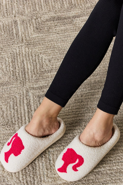 Melody Graphic Cozy SlippersStep into warmth and style with Melody Graphic Cozy Slippers. Made with plush material and festive details, these flats offer comfort and fashion for the winter seasSlippersPlush Fashion ShopPlush Fashion ShopMelody Graphic Cozy Slippers