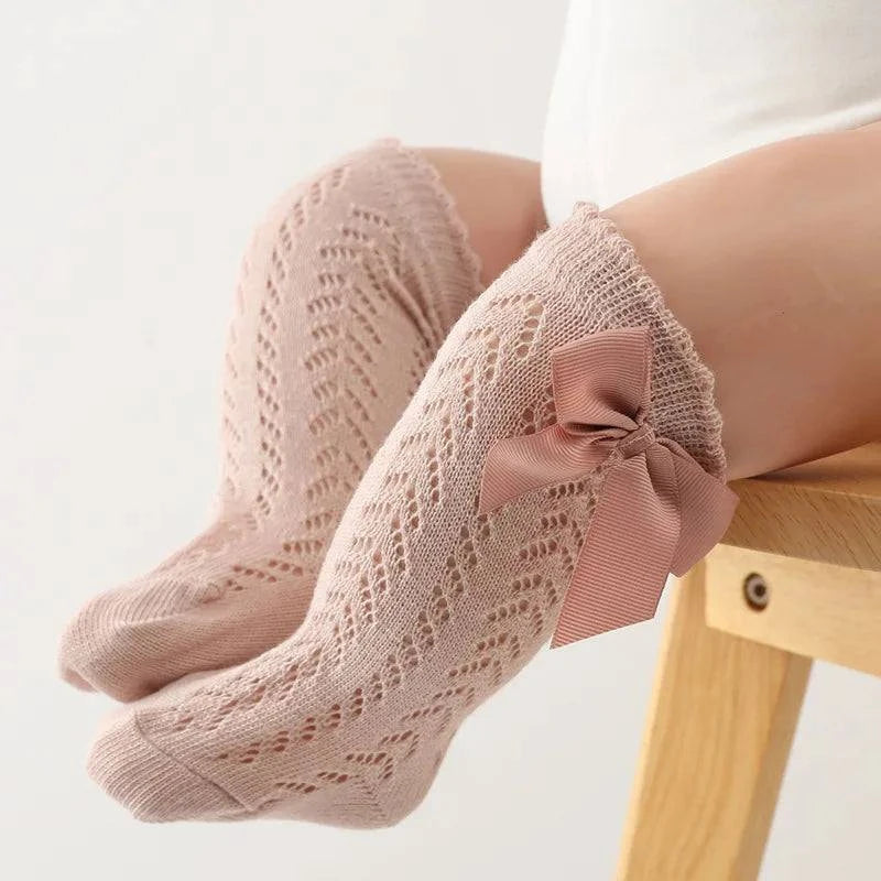 Baby Girls Long Bow SockWrap your little one's feet in soft cotton with our Baby Girls Long Bow Sock. These knee-highs feature a Spanish-inspired design with delicate lace detailing, perfecSocksPlush Fashions ShopPlush Fashion ShopBaby Girls Long Bow Sock