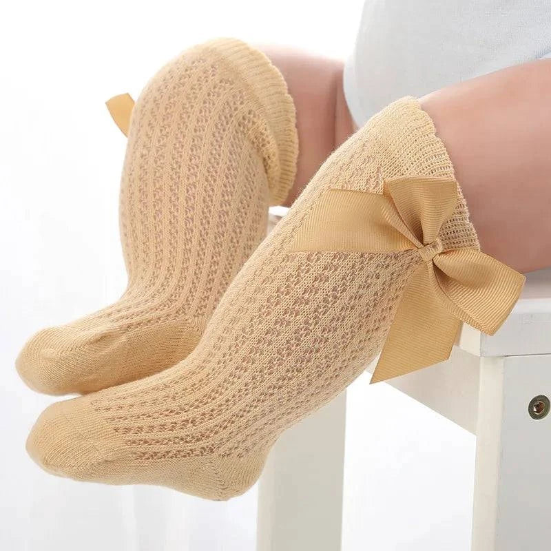 Baby Girls Long Bow SockWrap your little one's feet in soft cotton with our Baby Girls Long Bow Sock. These knee-highs feature a Spanish-inspired design with delicate lace detailing, perfecSocksPlush Fashions ShopPlush Fashion ShopBaby Girls Long Bow Sock